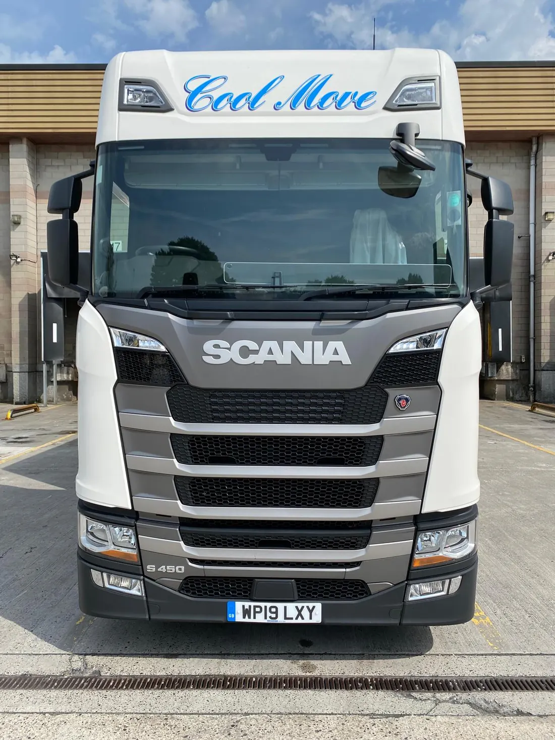 Head-on close-up of a Cool Move Scania S450 cab, the blue Cool Move script above the Scania grille.